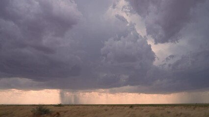 Wall Mural - View of rainstorm in West Texas from vehicle while storm chasing moving in slow motion.