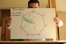 Young Mathematician And Designer Pavel Kubarkov And His Drawing Regular Heptagon With Green And Blue Colours On The Paper In Hands. Photo Was Taken 14 May 2022 Year, MSK Time In Russia.