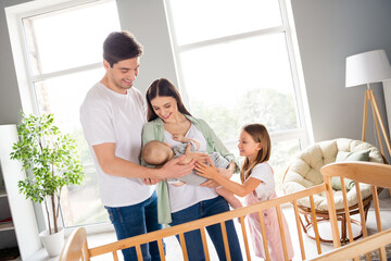 Poster - Portrait of full idyllic peaceful family embrace hands hold newborn baby enjoy weekend house indoors