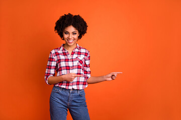 Wall Mural - Photo of positive nice person direct fingers empty space proposition blank isolated on orange color background