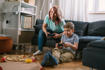 Wall Mural - mother and son playing video games at home