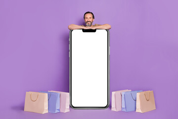 Sticker - Full body photo of mature man do shopping near promo isolated on purple background