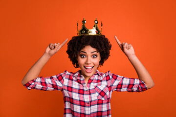 Sticker - Portrait of excited crazy lady indicate fingers head crown stare speechless isolated on orange color background