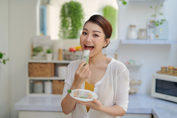 Wall Mural - woman eating healthy spring roll