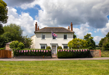 A house decorated with flags to celebrate the Queen's Platinum Jubilee in Long Melford, Suffolk, UK