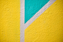 A Yellow And Blue Wall Painted With Stripes And A Triangle