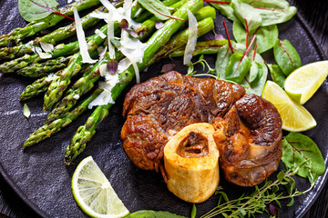 Wall Mural - braised osso buco with grilled asparagus, top view