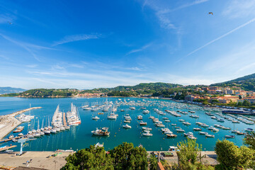 Wall Mural - Elevated view of the port of Lerici with many recreational boats moored and the village of San Terenzo. Tourist resorts on the coast of Gulf of La Spezia, Liguria, Mediterranean sea, Italy, Europe.