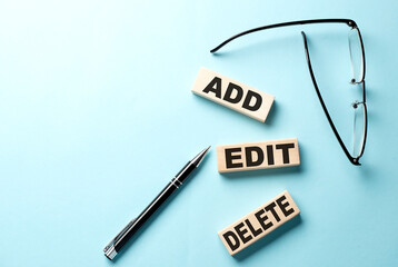 Text ADD, EDIT, DELETE concept on wooden block on the blue background