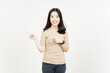 © Sino Images Studio - Showing Product and Pointing Side Of Beautiful Asian Woman Isolated On White Background