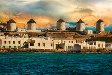 Traditional Greek Windmills Of Mykonos Island Over Sunset. Greece, Cyclades