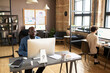 © pressmaster - Business people sitting at their workplaces and working on computers at modern office