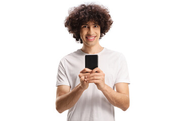 Sticker - Cheerful casual young man with a dark curly hair using a smartphone and looking at camera