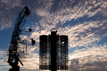 Wall Mural - Air defense radars of military mobile anti aircraft systems (radar is designed  and automatic tracking of targets and missiles) , modern army industry on background clouds and sky,Russia