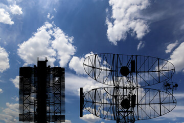 Wall Mural - Air defense radars of military mobile anti aircraft systems (radar is designed  and automatic tracking of targets and missiles) , modern army industry on background clouds and sky,Russia