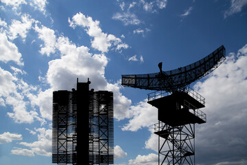 Wall Mural - Air defense radars of military mobile anti aircraft systems (radar is designed  and automatic tracking of targets and missiles) , modern army industry on background clouds and sky,Russia