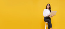 Young Woman Asian Happy Smiling. While Her Using Laptop Sitting On White Chair And Looking Isolate On Copy Space Yellow Background.