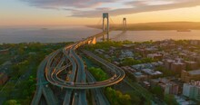 Complicated System Of Roads Leading To Throgs Neck Bridge. Impressive Bridge Structure In The Rays Of Setting Sun.