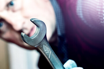 Wall Mural - The master holds a large wrench in his hand