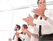 © ASDF - business background.applauding business team standing in the office