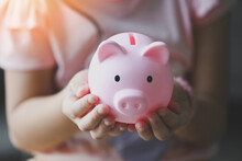 Child Woman Hand Hold Pink Piggy Bank For Saving Money For Education Study Or Investment , Save Money Concept, Daughter Hands Holding Pink Piggy Bank