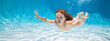 Happy kid swims in pool underwater, active kid swimming under water, playing and having fun, Children water sport. Summer holiday with children.