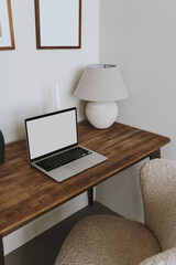 Wall Mural - laptop computer with blank copy space screen on table with lamp and comfortable chair. aesthetic hom