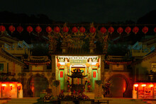 Temple In Night With Flowers And Lantern
