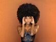 Black female model with fluffy hair in studio