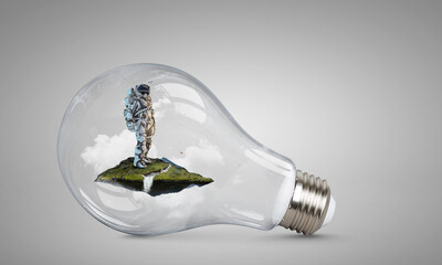 Wall Mural - spaceman inside light bulb . mixed media