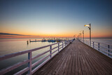 Fototapeta  - Sunrise over the pier in Mechelinki.