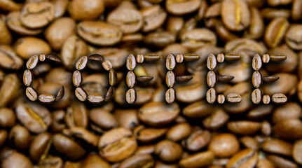 Wall Mural - The word Coffee is made from coffee beans on a coffee background