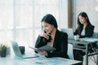 © Kritdanai - Businesswoman or accountant using the phone to check business information. Accounting Documents and Laptop Computer at Office Business Ideas