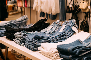 Wall Mural - Stack Of Jeans On Shelves In Store Of Shopping Center. shelf display in shop mall store. Store Of Shopping Center. retail sale.