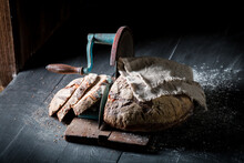 Loaf Of Bread On Slicer With Flour