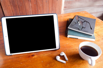 Cropped shot view of tablet and office desk table with the office equipments, and other office supplies on the modern space, flat lay.work at home.