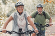 © Daniel - Two happy old mature people enjoying and riding bikes together to be fit and healthy outdoors. Active seniors having fun training in nature.