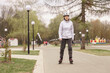 © alenaphoto - woman wearing a white helmet and white jacketon roller skates at a park