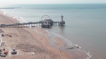 Wall Mural - Aerial Drone Shot of the famous Scheveningen Beach Pier near The Hague, Netherlands on a sunny overcast day