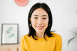 © Xavier Lorenzo - Happy asian teenager girl smiling at camera indoors - Portrait of chinese school student standing in her room