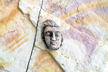 Sacred Ceramic Face On Sandstone. 