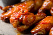 Chicken wings in sweet chili mango sauce extreme macro close up