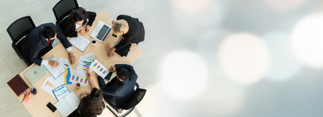 Business people group meeting shot from top widen view in office . Profession businesswomen, businessmen and office workers working in team conference with project planning document on meeting table .