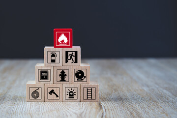 Wall Mural - Cube wooden block stack with fire prevent icon and door exit sing or fire escape with fire extinguisher and emergency prevention symbol or protection symbol for safety and rescue.