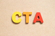 Color Alphabet Letter In Word CTA (Abbreviation Of Call To Action Or Chartered Tax Adviser) On Wood Background