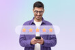 © Damir Khabirov - Satisfied client in purple shirt and glasses giving five star feed back using phone app