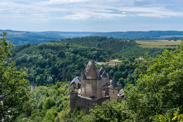 Sticker - the historic Vianden Castle in Luxembourg in midst of lush green summer forest