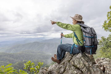 Young traveler woman with stylish backpack  looking forward at amazing mountains view. Enjoying nature, relax, pleasure.