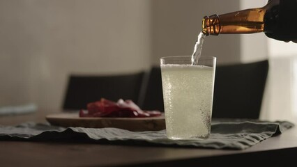 Wall Mural - Slow motion pour ginger drink in tumbler glass on table with copy space