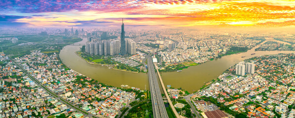 Wall Mural - Top view aerial of center Ho Chi Minh City at sunset scene with development buildings, transportation, energy power infrastructure. Financial and business centers in Vietnam. View from District 2